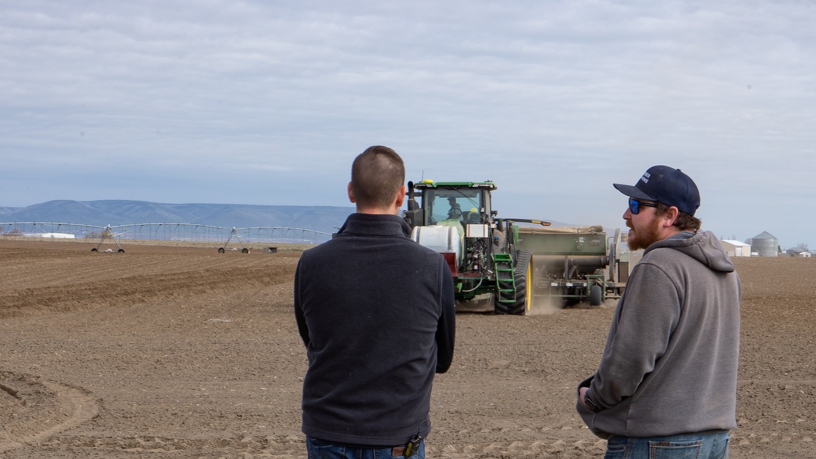 yara rep and farmer watching planting at incubator farm